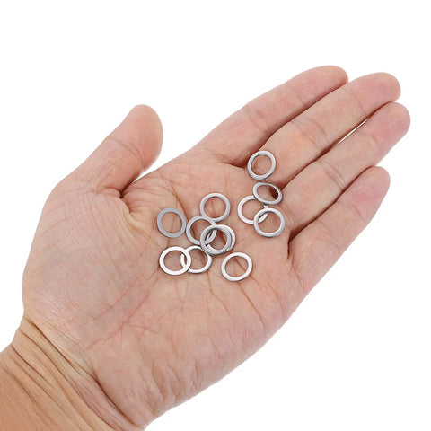 Hecka Durable M8 Flat Washers Set Of Twenty Thickened 304 Stainless Steel Spacers With Burr Free Edges in a hand showing ten pieces.