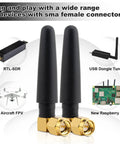 Two black antennas for 433MHz Omnidirectional SMA Male 3dBi Thumb Antenna with various compatible devices in background