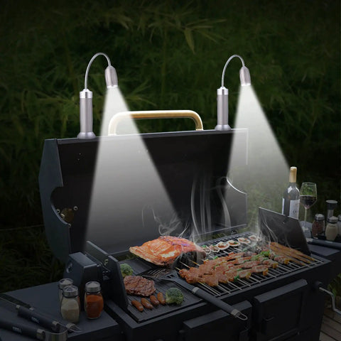 Ultra Bright Magnetic Grill Light With Flexible Gooseneck LED Beam Hands Free BBQ Lighting illuminating food on a grill at night.