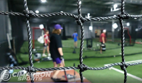 Inside a Fully Enclosed Baseball Softball Batting Cage Net With Easy Entry Door Built Tough For All Weather, players practicing