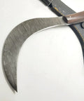 Hand Crafted Damascus Steel Sickle Knife With Full Tang And Stabilized Rosewood Handle displayed with sheath