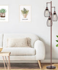 Dimmable Farmhouse Industrial Floor Lamp With Teardrop Cage Head, 70 Inch Tall, in living room next to sofa, brown finish.