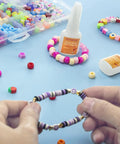 Clear Jewelry Glue For Elastic String With Built-In Brush, Quick-Dry Craft Adhesive for bracelets and beading projects.
