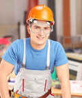 Tough As Nails Safety Goggles Featuring Antifog Coating And Impact Resistant Lenses on a worker with an orange hard hat.