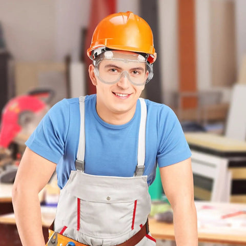 Tough As Nails Safety Goggles Featuring Antifog Coating And Impact Resistant Lenses on a worker with an orange hard hat.