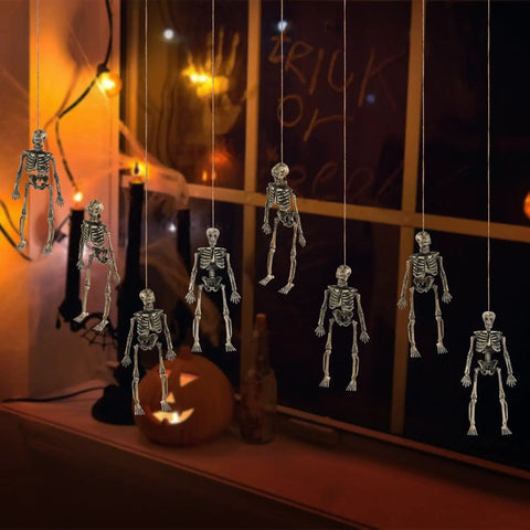 Six Pack Five Point Nine Inch Poseable Mini Skeleton Figurines Distressed Plastic Skeletons For Crafts And Halloween Decor hanging by window