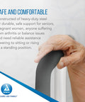 Hand gripping the padded support handle of a No Sweat Install With Quick Clips Padded Rails Offer Rock Solid Grip Adjustable Width Fits All Bowls Carries 300 Lbs Like A Champ White Bathroom Safety Bar.