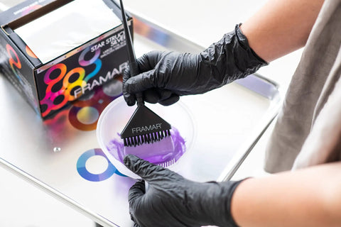 Person applying purple dye wearing Powder Free Nitrile Gloves 12 Inch Pro Grade Extra Durable Black Disposable Latex Free