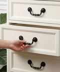 Four Pack Retro Drop Bail Drawer Pulls With Screws Black Finish Large Size L on white furniture drawer being opened