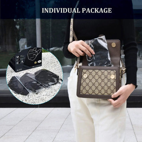 Person placing KN95 5 Ply Face Mask Pack Of 30 All Day Comfy Breathable Safety Mask Black into a bag, individual packages visible