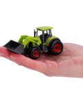 Hand holding mini tractor from Five Piece Green Die Cast Farm Machinery Toys Set With Mini Tractors And Harvesters, 4.5 cm