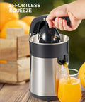 Electric Citrus Juicer With Brushed Stainless Steel Finish extracting juice into a glass, showcasing its dual-size cone feature.