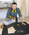 Man using non slip 2mm thick work bench pad 48 by 17 inch textured PVC mat for woodworking DIY garage and tabletop protection.