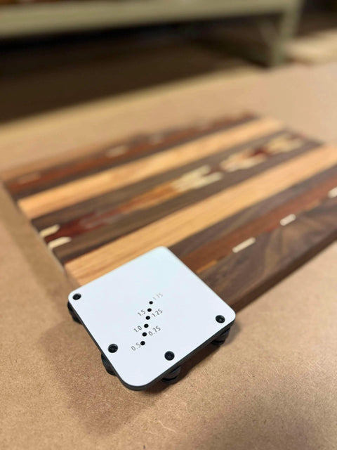 Must Have Cutting Board Foot Jig For Woodworking That Delivers Fast Precise Marking Drilling Or Punching One Eighth Inch Holes With A Heavy Duty 7mm Phenolic Locating Plate Built To Last on a wooden surface