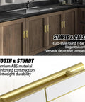 Close-up of gold self-adhering push pull handles on wood cabinet, showing ABS plastic material, part of 10 Pack Self Adhering Push Pull Handles ABS Plastic For Wardrobe Cabinets Drawers Instantly Improve Access With No Drilling Leaves No Traces On Smooth Surfaces Gold Finish Durable Easy To Install.