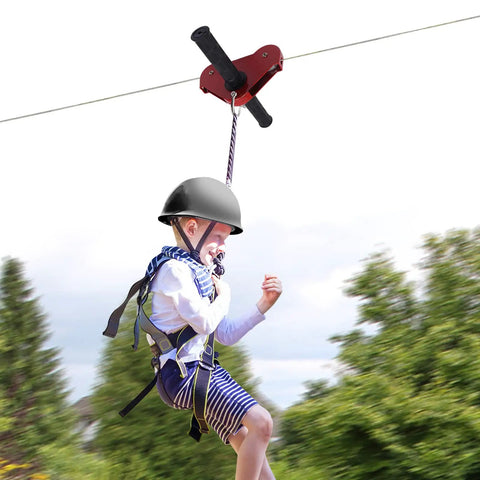 Child using Backyard Zip Line Kit For Kids And Adults Up To 330 Lb, 120 Ft Stainless Steel Zip Line With Spring Brake, Safety Harness And Helmet