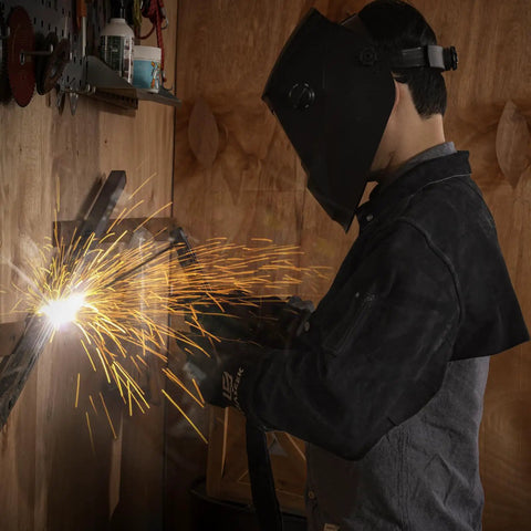 Heavy Duty Welding Cape Sleeve Made From Tough Split Cowhide Leather Flame Resistant Welder Jacket during welding with sparks.