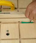 Hand adjusting MicroJig MatchFit Pop Stop 6-Pack: Pro Go-To Dovetail Track Stops on a woodworking jig with screwdriver