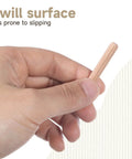 Hand holding a 1/4 x 1-1/2 inch wood dowel pin, highlighting fluted surface for the 100 Count 1/4 Inch Wood Dowel Pins product.