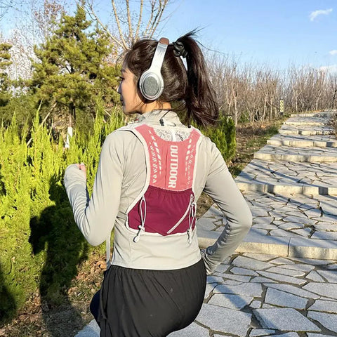 Back view of woman running with Lightweight Running Vest Hydration Backpack With Breathable Mesh Back Reflective Outdoor Daypack.