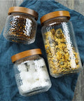 Keep Your Stash Fresh With These Top Notch Sealed Tea Canisters And Coffee Bean Jars Crafted From Durable Glass Super Simple Kitchen Pantry Storage Essentials That Are Actually Worth The Buy Hella Convenient three glass storage jars with wooden lids for dry goods.