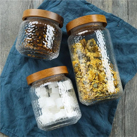 Keep Your Stash Fresh With These Top Notch Sealed Tea Canisters And Coffee Bean Jars Crafted From Durable Glass Super Simple Kitchen Pantry Storage Essentials That Are Actually Worth The Buy Hella Convenient three glass storage jars with wooden lids for dry goods.