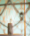 Close-up of light bulb in Rustic Woven Pendant Light Fixture Tan With Rope Shade Boho Three Light Ceiling Lamp 14.5 Inch High 20 Inch Wide