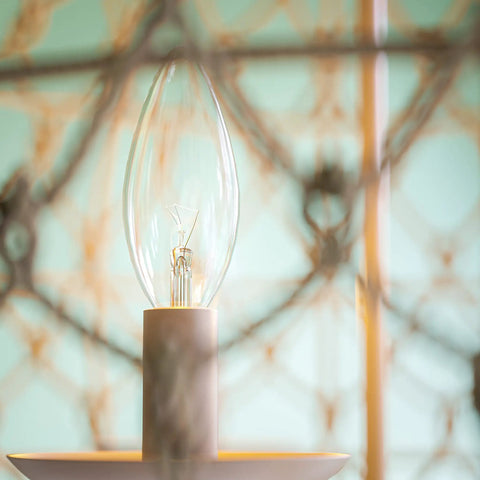 Close-up of light bulb in Rustic Woven Pendant Light Fixture Tan With Rope Shade Boho Three Light Ceiling Lamp 14.5 Inch High 20 Inch Wide