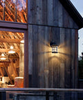 10 Inch Black Outdoor Coach Lights With Seeded Glass Shade Waterproof Patio Wall Lights illuminating rustic porch