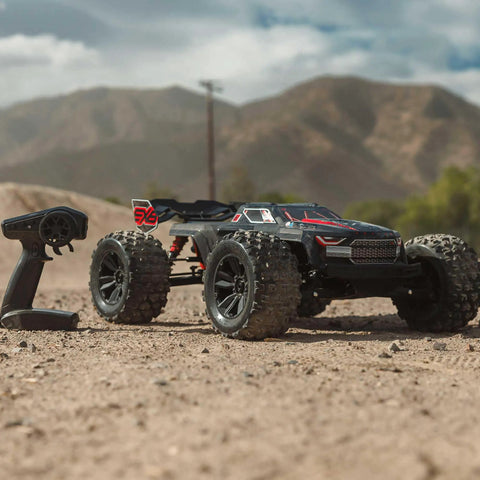 ARRMA Kraton 1 8 Scale 6S EXB Ready To Run Clipless Body Basher Monster RC Truck on dirt with controller in foreground