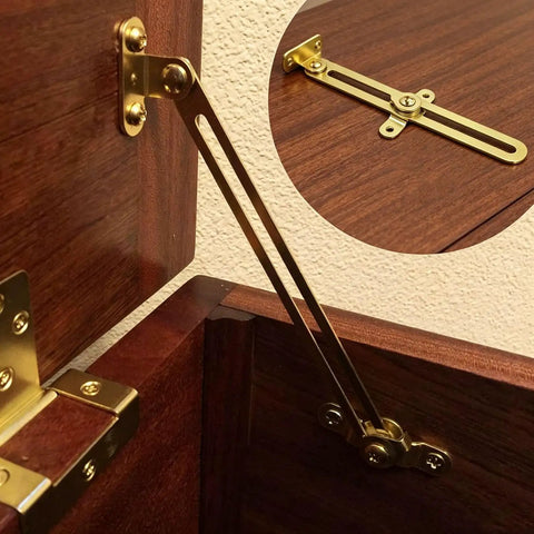 Gold hinge attached to wooden cabinet, part of Two Pack Gold Friction Lid Support Hinges For Cabinets And Jewelry Boxes Adjustable Downward Lid Aids That Prevent Slams Includes Screws Sturdy Iron Construction Fits Wooden Cabinets Trunks Vintage Furniture.
