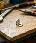 Heavy Duty 40 Piece Stainless Steel L Bracket Set With Screws For Wooden Surfaces on a workbench.