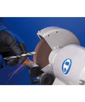 Person sharpening a drill bit on a Heavy Duty 6 Inch Vitrified Bench Grinding Wheel 60 Grit Thick Profile.