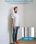 Man using Wall Mounted Height Gauge For Home Or Clinic, Aluminum Stadiometer With 10 To 225 Cm Range, dual scale visible in use