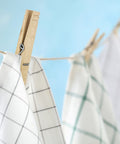 Tough As Nails Wooden Clothespins With Heavy Duty Spring Clip For Line Drying Laundry And Chip Bag Sealing Rust Resistant Coiled Design Non Slip Grip Bulk Pack Of 50 Absolute Go To For Crafting And Home Storage used to hang kitchen towels on a clothesline.