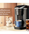 Kick Up Your Morning Routine With This Dope Single Serve Coffee Maker Featuring K Cup Compatibility Strong Brew And Iced Settings Programmable Temp Control Plus Multiple Cup Sizes In Solid Brushed Slate in use, brewing hot coffee and iced drink.