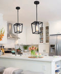 Black Pendant Light For Kitchen Island, 1 Light Modern Farmhouse Cage Lantern With Glass Shade hanging over white kitchen.