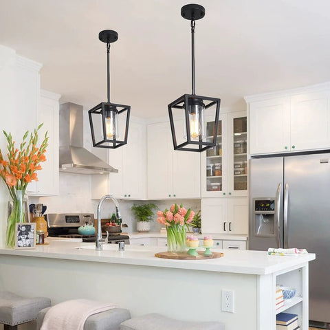 Black Pendant Light For Kitchen Island, 1 Light Modern Farmhouse Cage Lantern With Glass Shade hanging over white kitchen.