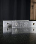 Close-up of One Eighth Inch Precision Steel Parallels, 6 Inch Long, 10 Pair Set, Ground And Hardened on a reflective surface