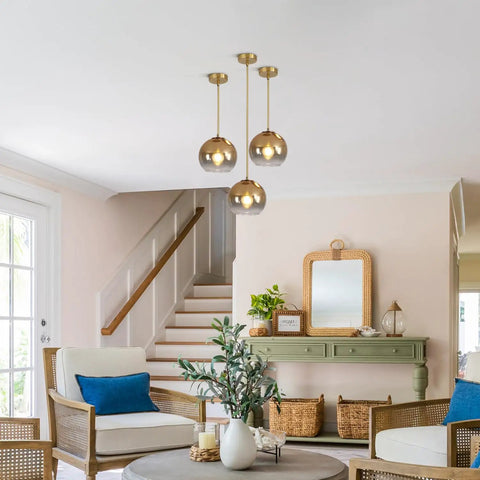 Gradient Gold Glass Pendant Light For Kitchen Island, three globe fixtures hanging in a cozy living room with warm ambience.