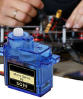 Close-up of SG90 Micro Servo Motor Kit 3 Pack for Arduino and Raspberry Pi DIY Projects in front of a DIY setup