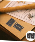 Vintage Iron Jewelry Box Hinges With Screws Small Retro Decorative Cabinet Door Hinges and hardware on wooden surface.