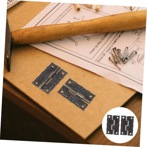Vintage Iron Jewelry Box Hinges With Screws Small Retro Decorative Cabinet Door Hinges and hardware on wooden surface.