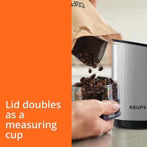Krups Electric Coffee Grinder With 3 Oz Capacity And 200 Watt Motor Grinds Beans, Spices, And Nuts Easily, measuring cup lid in use.
