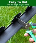 Person cutting No Dig Landscape Edging Kit For Flower Beds And Lawns 33 Ft Border 2 Inch Tall Plastic Garden Border with scissors