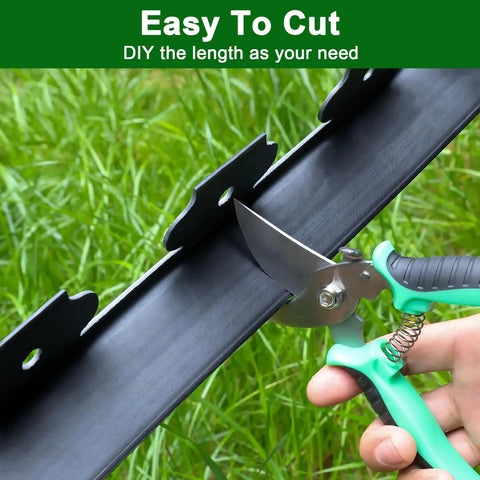 Person cutting No Dig Landscape Edging Kit For Flower Beds And Lawns 33 Ft Border 2 Inch Tall Plastic Garden Border with scissors
