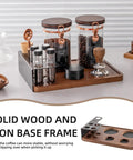 Keep Your Beans Locked Away In This Coffee Canister Set With Two Sealed Glass Jars With One Way Degassing Valves And Dark Blocking Lids Includes Four Dosing Tubes Measuring Spoon Funnel And Sturdy Rack For Your Daily Grind Routine displayed on a wood and metal storage tray.