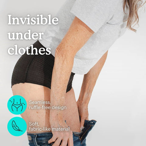 Heavy Absorbency Disposable Incontinence Underwear For Women Black XL being worn under clothing, seamless design, soft material.