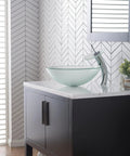 Tall Waterfall Vessel Sink Faucet In Oil Rubbed Bronze With Frosted Glass Disk installed on modern bathroom vanity.