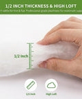 Close-up of hand measuring half inch thick polyester batting, showcasing premium softness for DIY upholstery. Kick Your Couch Back To Life With Premium Half Inch Thick Polyester Batting, Super Soft High Loft Polyfill Delivers Knockout Quality Cushion Wrap For Smooth Furniture Padding And Effortless Diy Fixes 36 By 9 Feet Roll.